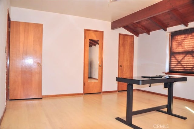 interior space with light hardwood / wood-style floors and vaulted ceiling