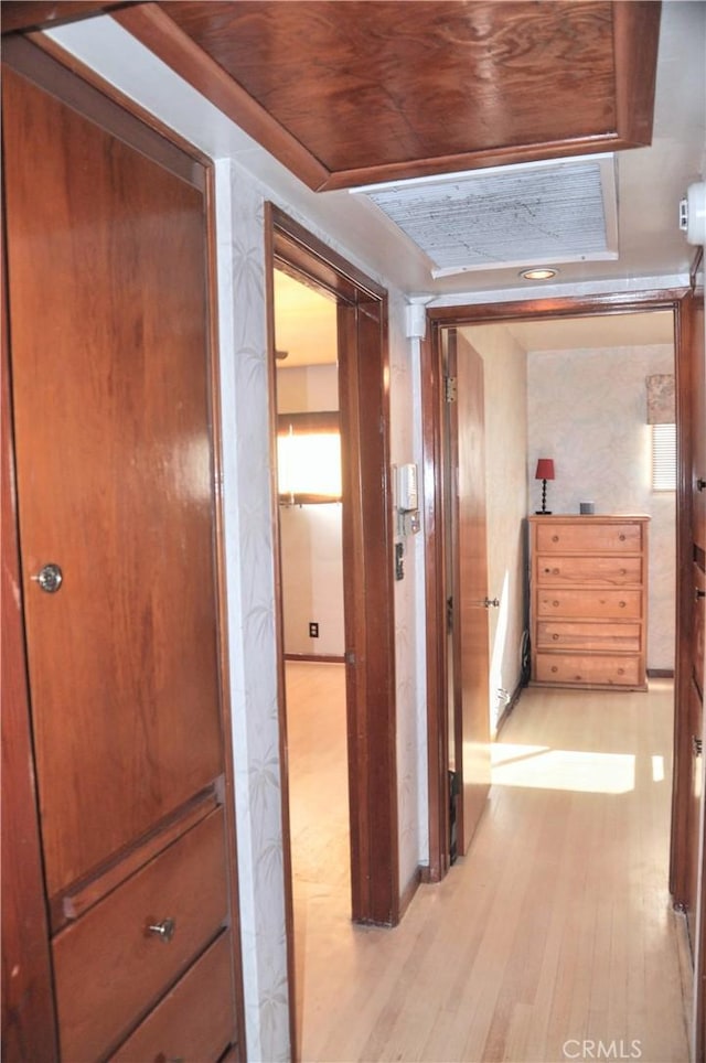 hall with wood ceiling and light hardwood / wood-style floors