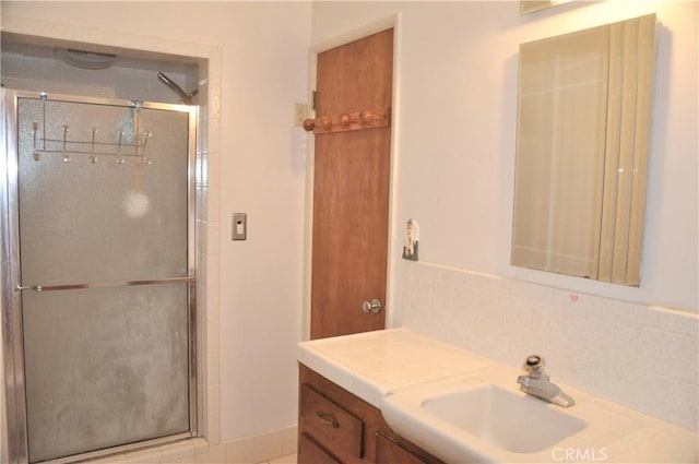 bathroom featuring vanity and a shower with shower door