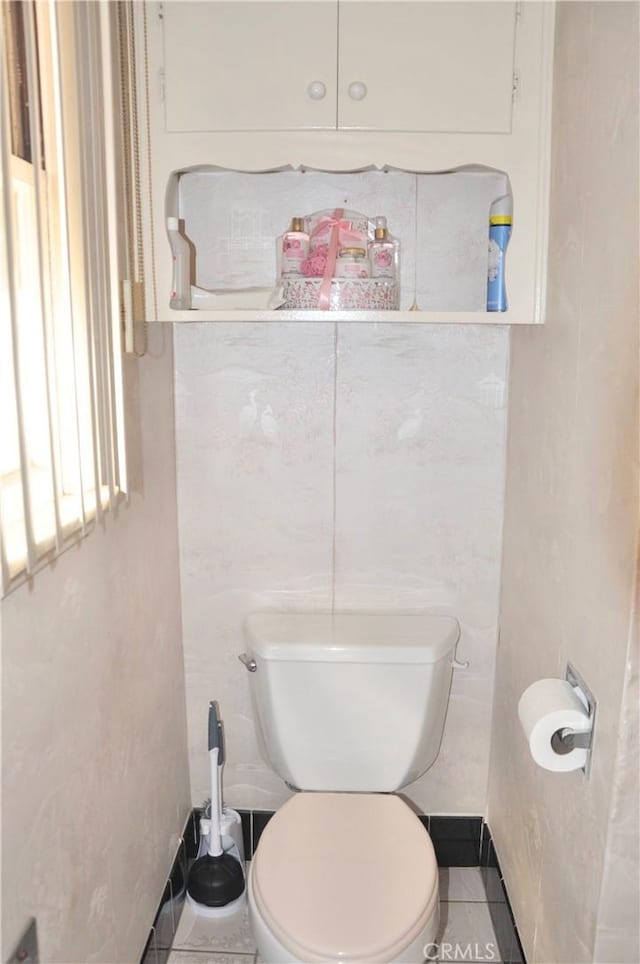 bathroom featuring toilet and tile patterned flooring