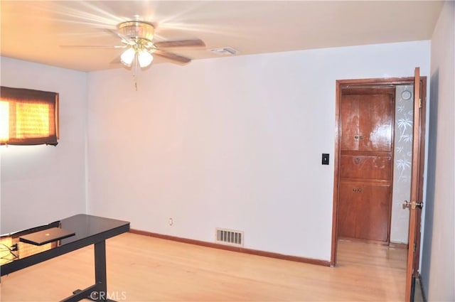 spare room with ceiling fan and light wood-type flooring