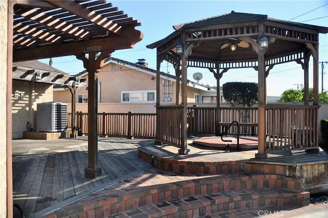 wooden deck with cooling unit, a pergola, and a gazebo