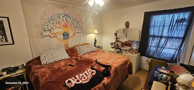 bedroom with hardwood / wood-style flooring and ceiling fan