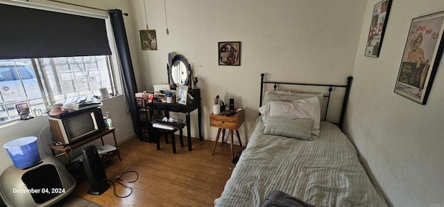 bedroom with hardwood / wood-style flooring