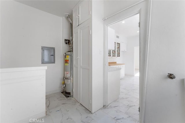 utility room featuring gas water heater and electric panel