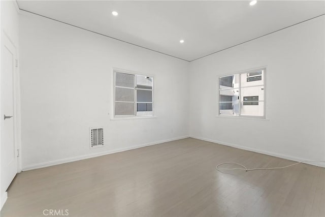 unfurnished room with light hardwood / wood-style floors