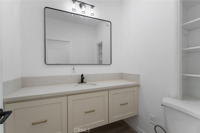 bathroom featuring vanity and toilet