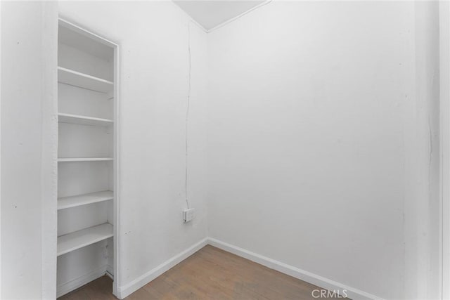 clothes washing area with hardwood / wood-style flooring