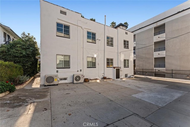 rear view of house featuring ac unit