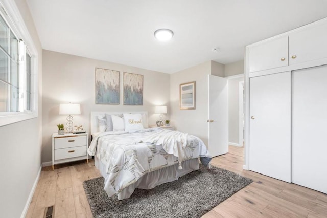 bedroom featuring a closet and light wood-type flooring