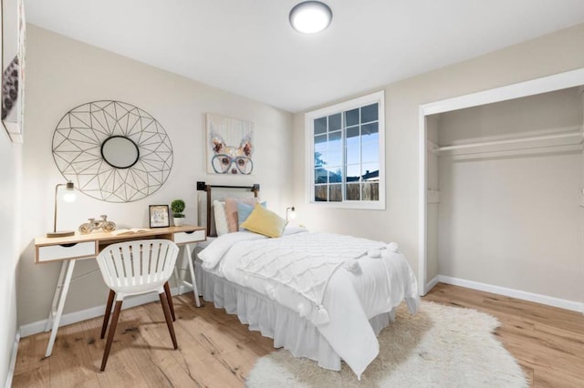 bedroom with a closet and light hardwood / wood-style flooring