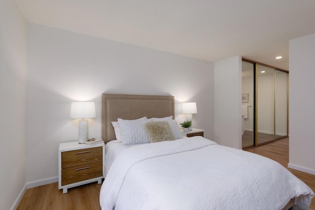 bedroom featuring a closet and light hardwood / wood-style flooring