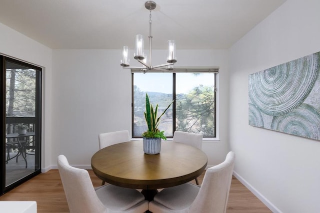 dining space with a chandelier and light wood-type flooring