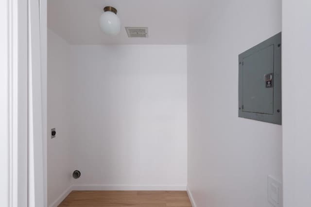 laundry area featuring hookup for an electric dryer, hardwood / wood-style floors, and electric panel