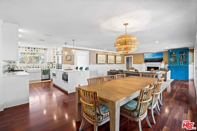 dining room featuring sink and dark hardwood / wood-style flooring