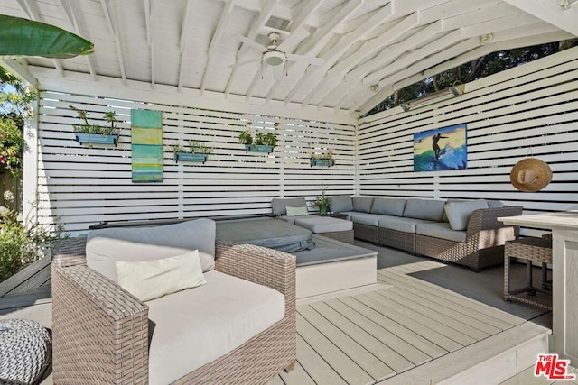 exterior space featuring an outdoor living space and ceiling fan