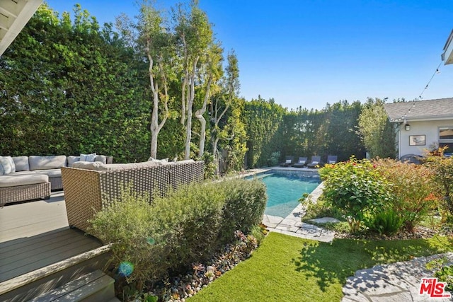 view of swimming pool featuring a wooden deck and an outdoor hangout area