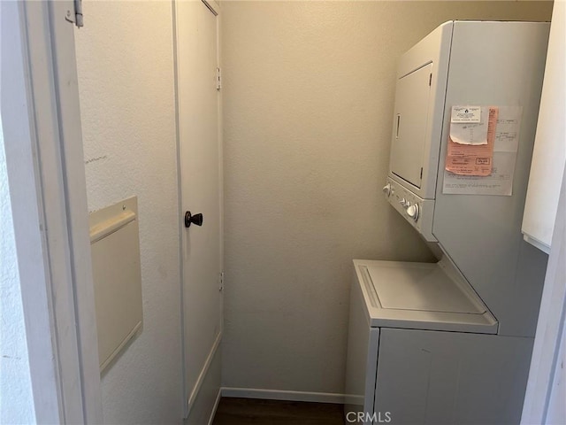 laundry room featuring stacked washer / drying machine