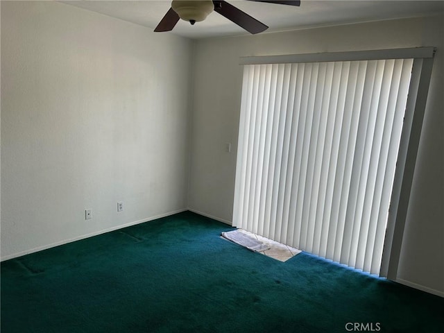 carpeted spare room featuring ceiling fan