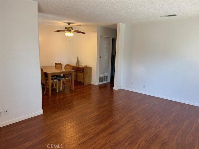 interior space with dark wood-type flooring, a textured ceiling, and ceiling fan