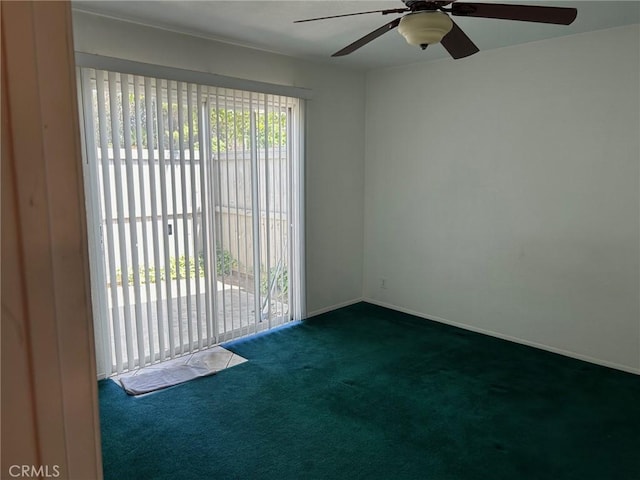 spare room with dark colored carpet