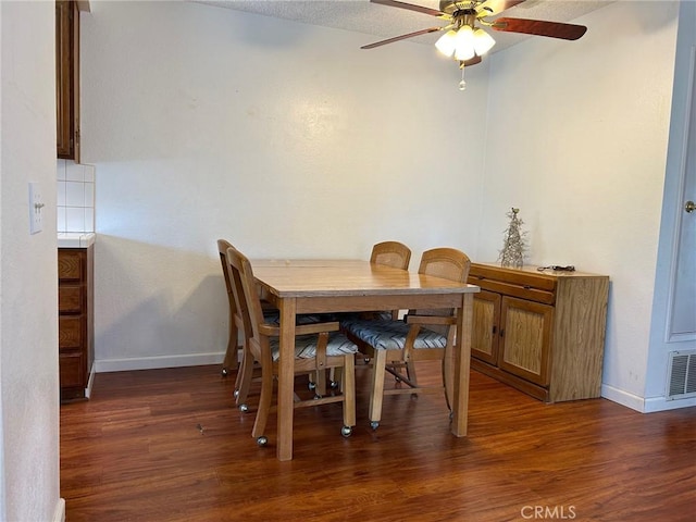 dining space with dark hardwood / wood-style floors and ceiling fan