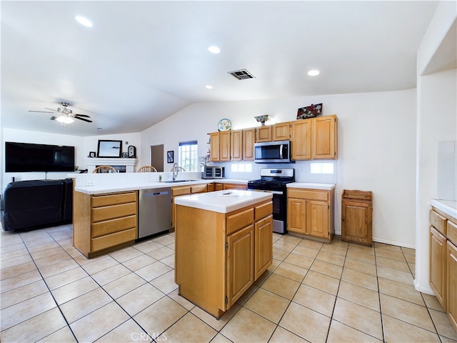 kitchen featuring light tile patterned flooring, a peninsula, visible vents, light countertops, and appliances with stainless steel finishes