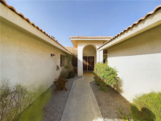 doorway to property featuring a patio and stucco siding