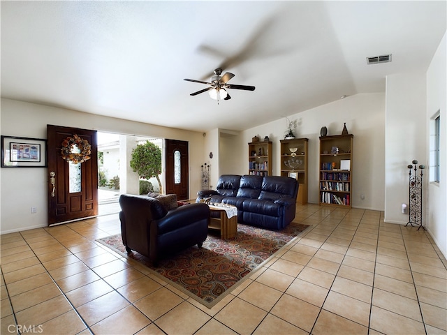 living area with light tile patterned floors, ceiling fan, lofted ceiling, and visible vents