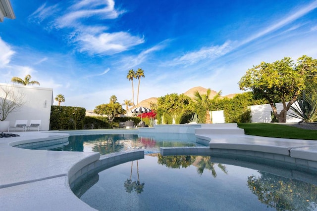 view of swimming pool with a mountain view and a patio area