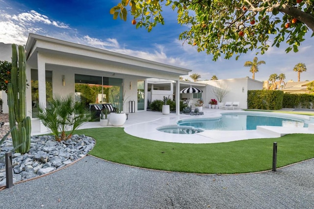 view of swimming pool featuring a yard and a patio