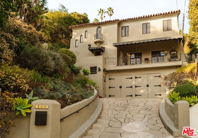 exterior space with a balcony and a garage