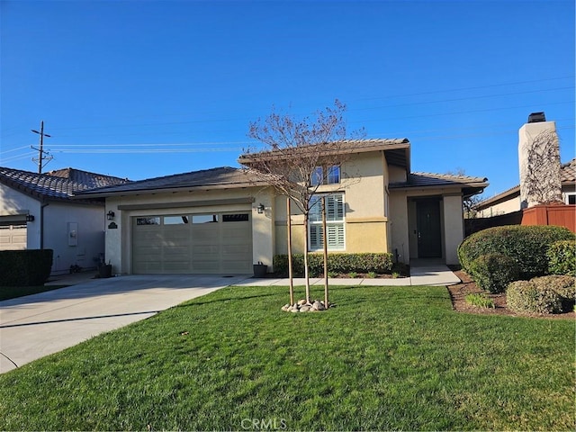 view of front of home featuring a garage and a front lawn