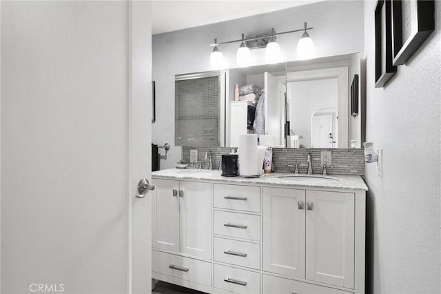 bathroom with tasteful backsplash and vanity