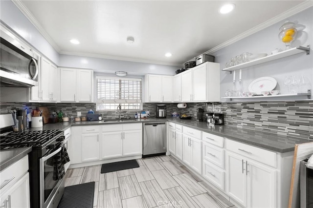 kitchen featuring white cabinetry, stainless steel appliances, sink, and decorative backsplash