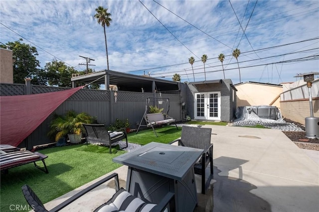 view of patio / terrace featuring french doors and an outdoor structure