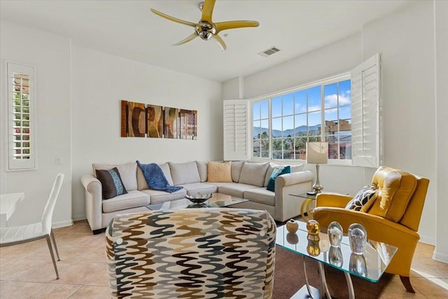 living room with ceiling fan and light tile patterned floors