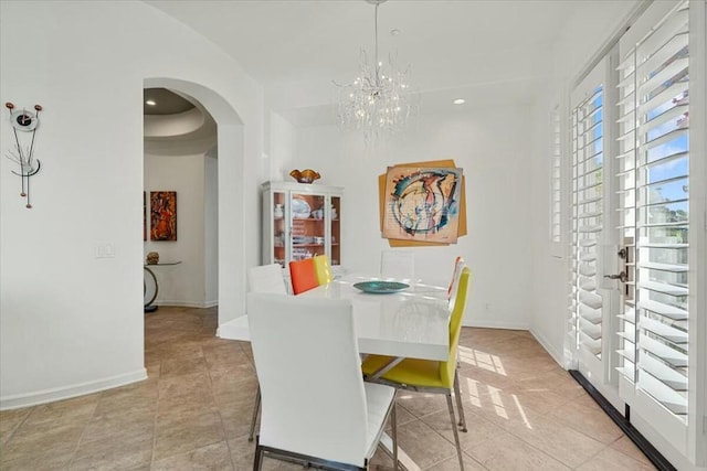 dining space featuring a chandelier and light tile patterned floors