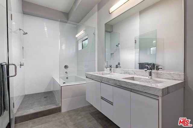 bathroom with tile patterned flooring, vanity, and separate shower and tub