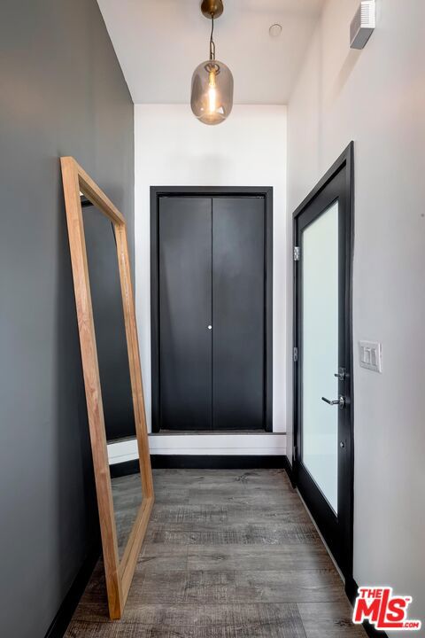 doorway with dark wood-type flooring