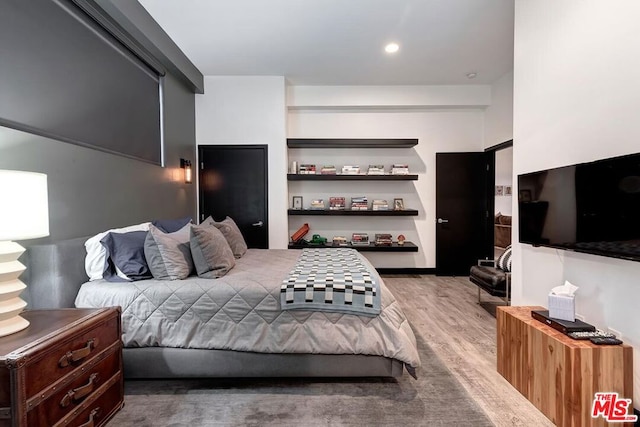 bedroom with hardwood / wood-style floors