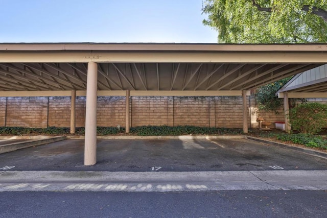 view of parking / parking lot featuring a carport