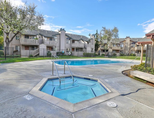 view of swimming pool featuring a community hot tub