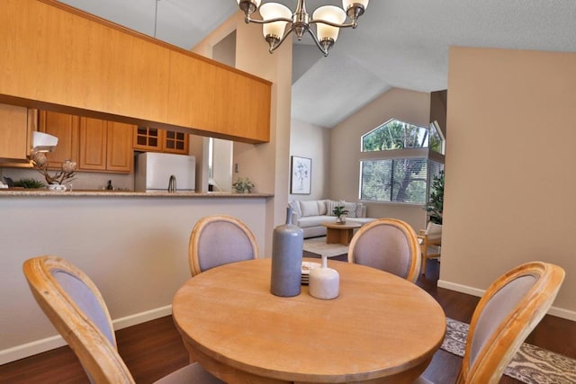 dining area with an inviting chandelier, dark hardwood / wood-style flooring, and vaulted ceiling