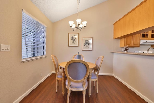 dining room with vaulted ceiling, an inviting chandelier, and dark hardwood / wood-style flooring