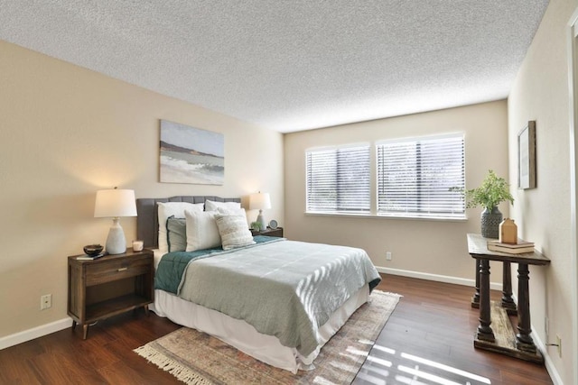 bedroom featuring dark wood-type flooring and a textured ceiling