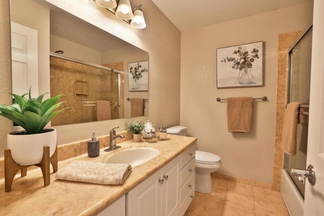 full bathroom with enclosed tub / shower combo, vanity, tile patterned floors, and toilet