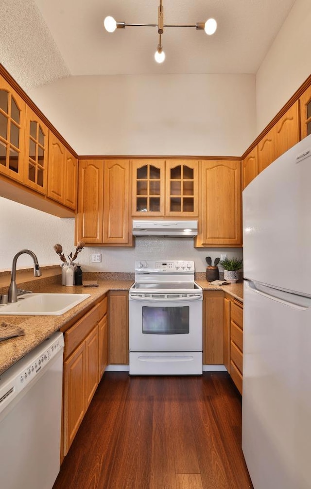 kitchen with sink, white appliances, and dark hardwood / wood-style floors