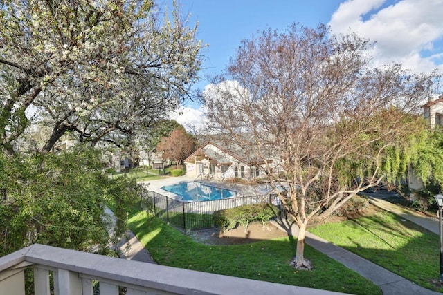 view of pool with a lawn