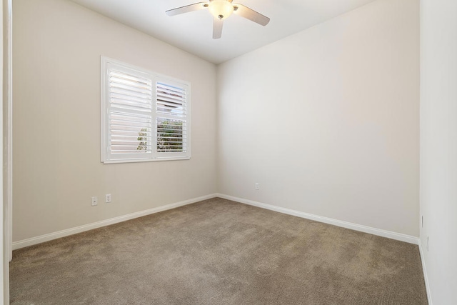 carpeted spare room featuring ceiling fan